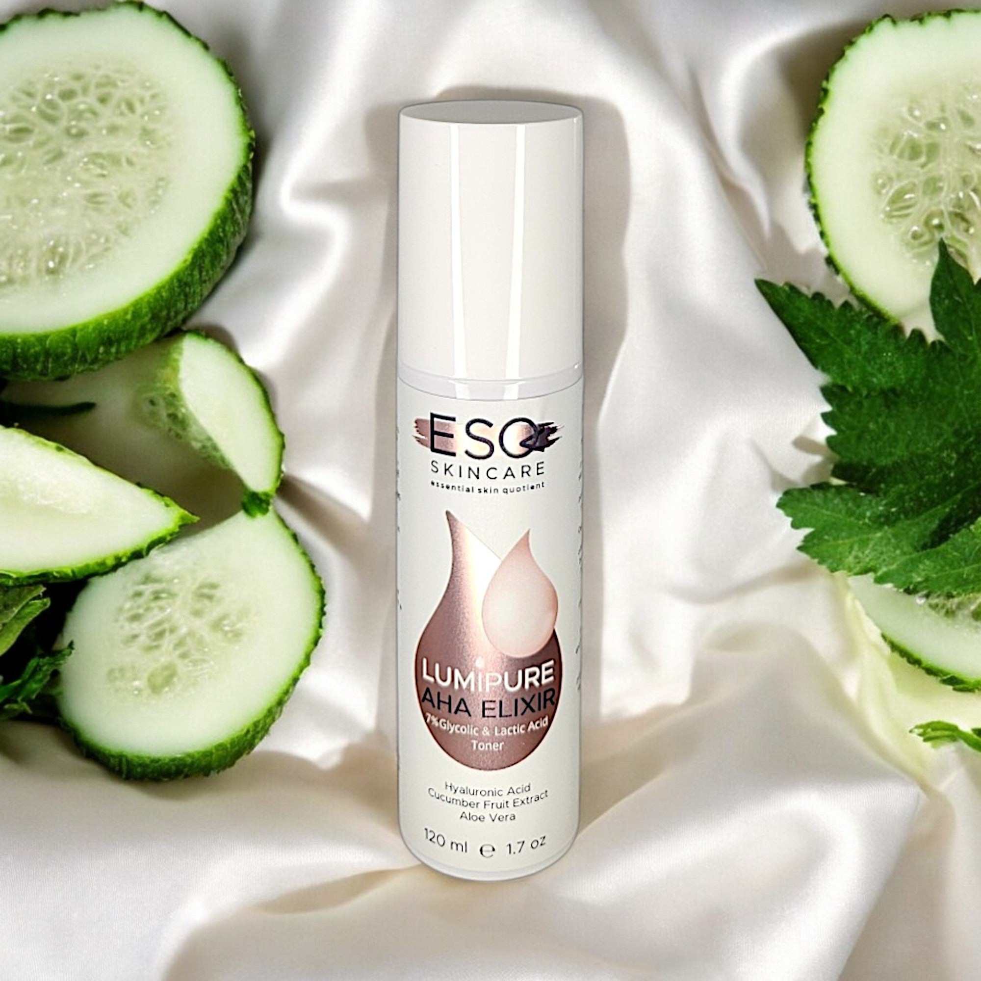 LumiPure AHA Elixir toner with 7% Glycolic & Lactic Acid, 120 ml bottle, surrounded by fresh cucumber slices and green herbs for glowing skin.