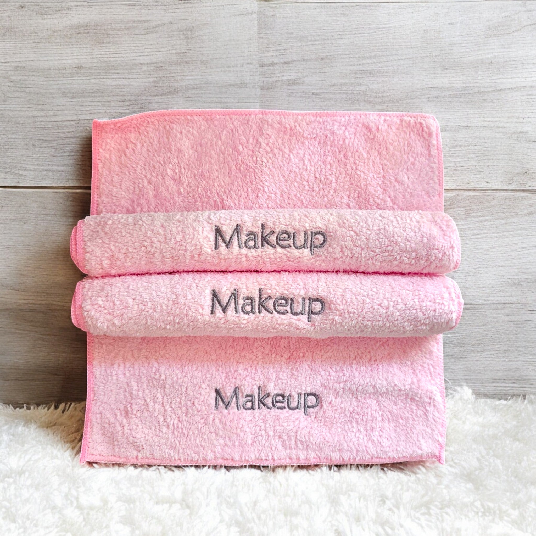 A soft, eco-friendly ESQ Skincare Clean Slate™ Microfiber Cloth in a neutral tone, neatly folded beside a skincare routine setup, highlighting its gentle, reusable, and sustainable design for effortless makeup removal. 🌿✨