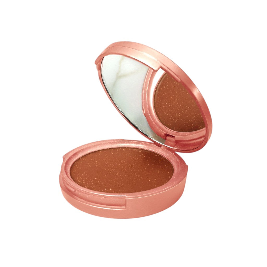 Compact bronzer with rose gold casing on a white background
