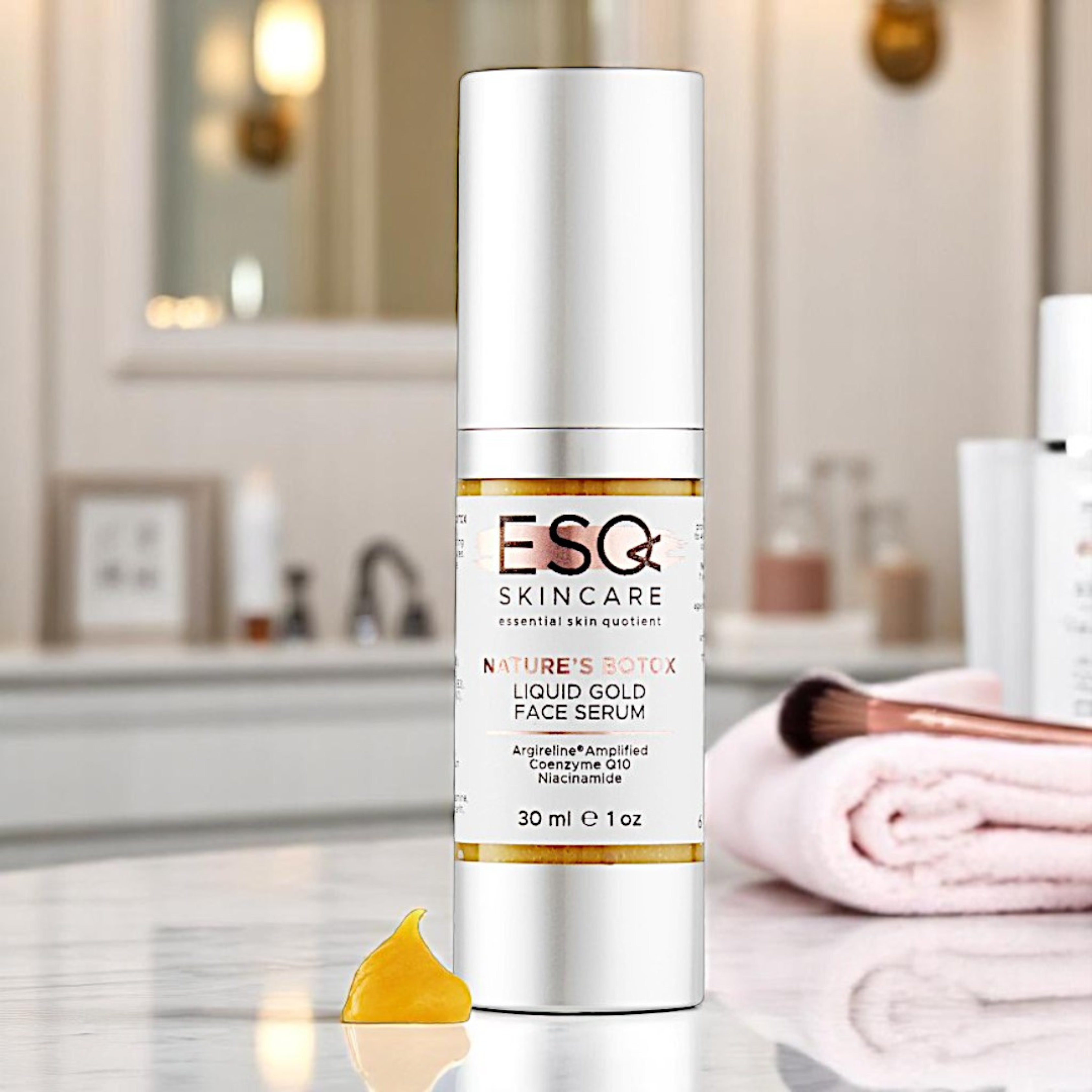 ESQ Skincare Liquid Gold Face Serum on a bathroom counter with blurred background