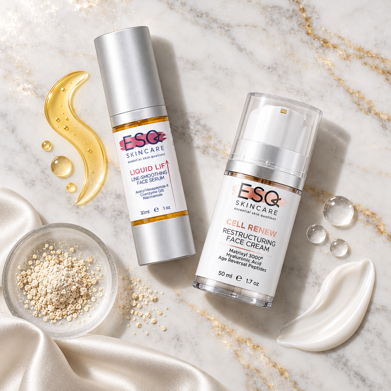 Two ESQ Skincare products arranged on a white marble surface with gold veining: a silver-topped Liquid Lip Strengthening Face Serum bottle and a clear-topped Cell Renew Restructuring Face Cream bottle, styled with a gold lip-shaped droplet, clear gel drops, a bowl of beige exfoliating beads, and white satin fabric.