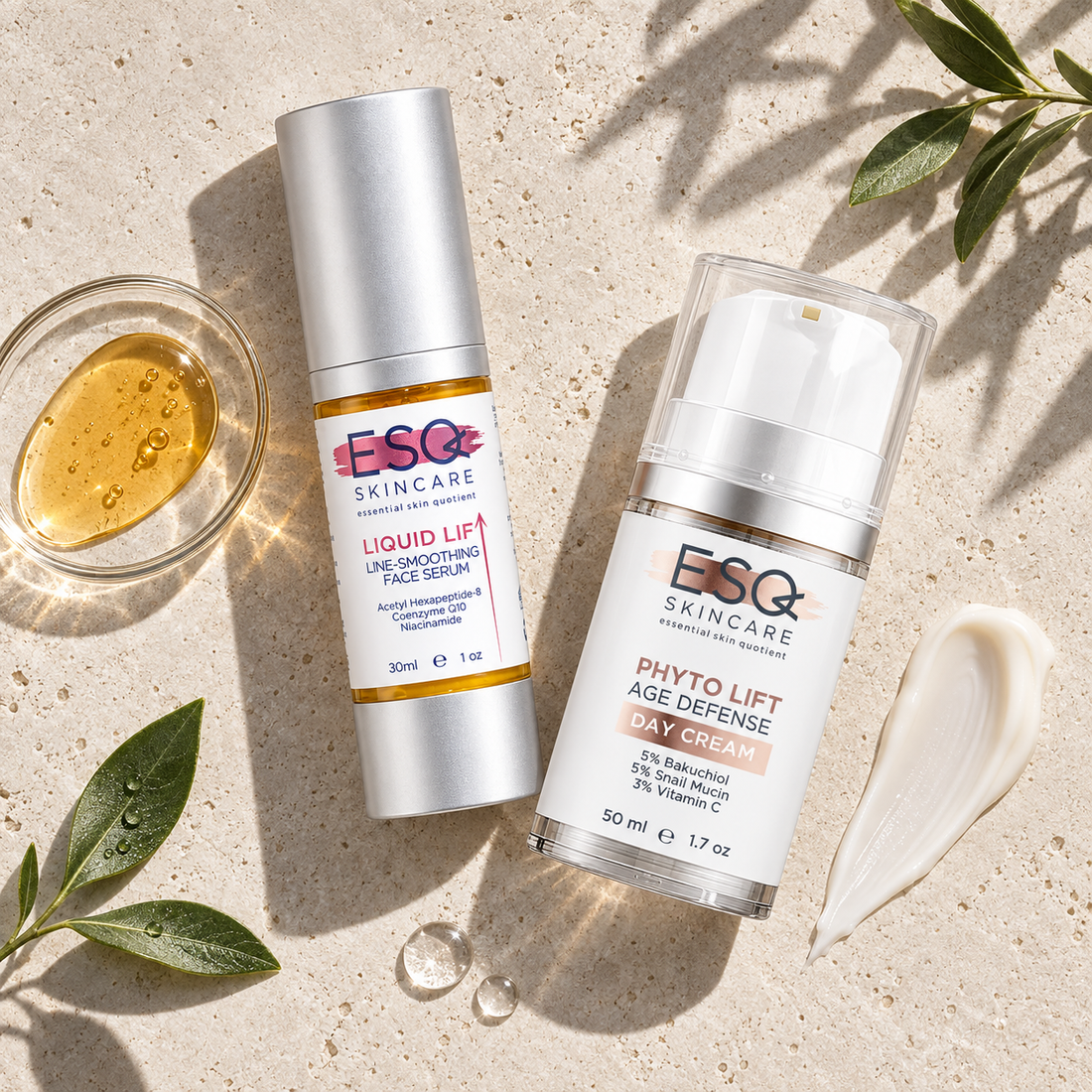 Two skincare products from ESC Skincare are displayed on a textured beige stone surface with natural leaves and a small glass of golden serum. The products are the Liquid Lift Line-Smoothing Face Serum and the Phyto Lift Age Defense Day Cream.
