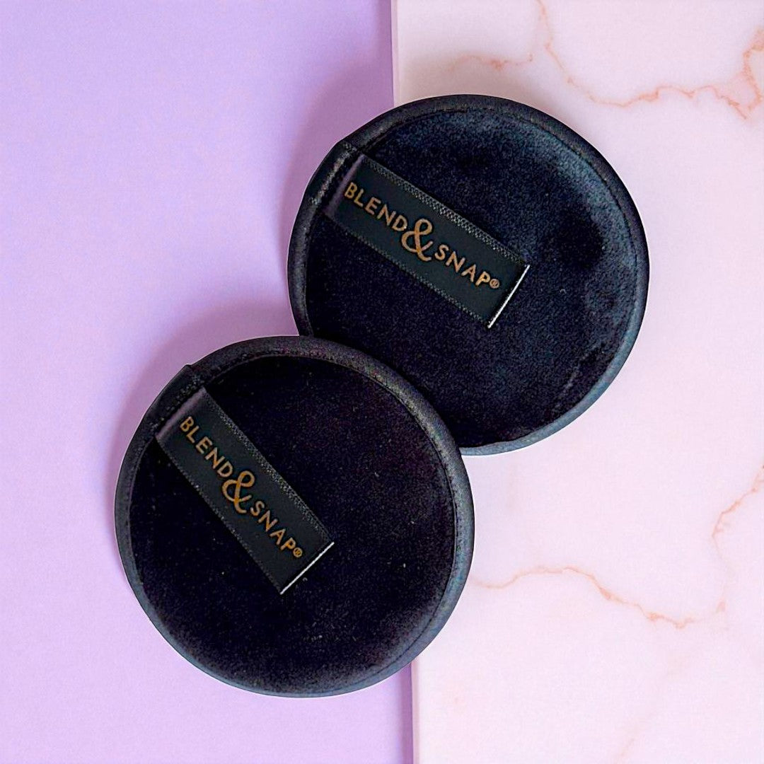 Black velvet jewelry boxes with 'Blend & Snap' branding on a light pink and white marble background.
